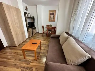 a living room with a couch and a table at Ramada 2 - Apartment in Bansko