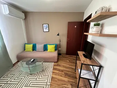 a small living room with a bed and a desk at Ramada 2 - Apartment in Bansko
