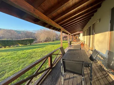 a wooden deck with a table and chairs on it at Villa Bachevo Horizon in Bachevo
