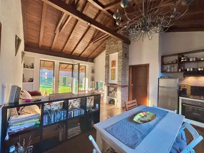 a living room with a table and a chandelier at Villa Bachevo Horizon in Bachevo
