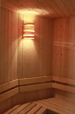 an empty wooden sauna with a light in it at Guest House Tabakovi in Velingrad
