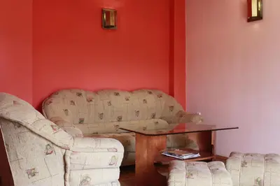 a living room with two chairs and a table at Guest House Tabakovi in Velingrad