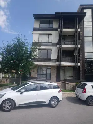 a white car parked in front of a building at Studio L006 in Aspen Golf in Bansko