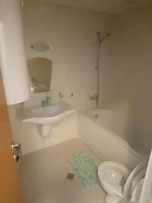 a bathroom with a sink and a tub and a toilet at Studio L006 in Aspen Golf in Bansko