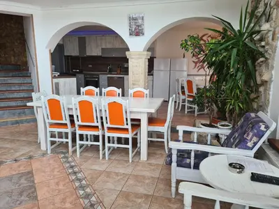 a kitchen and dining room with a table and chairs at Vila Kalvachevi in Tsigov Chark