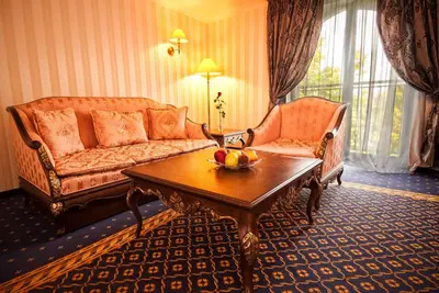 a living room with a couch and a coffee table at Hotel Chinar in Hisarya