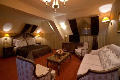 a hotel room with a bed and a couch at Hotel Chinar in Hisarya