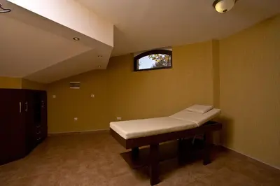 a room with a bench in a room with a window at Hotel Chinar in Hisarya