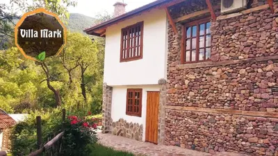 a stone building with a sign on the side of it at Villa Mark in Kraevo