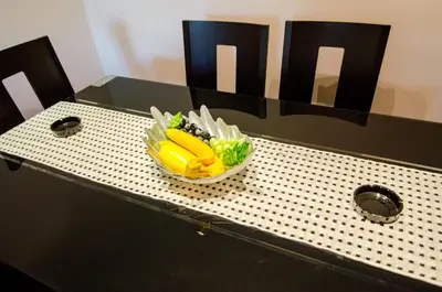 a table with a bowl of vegetables on it at Kapana Comfy 2BR Apartment in Top Center in Plovdiv
