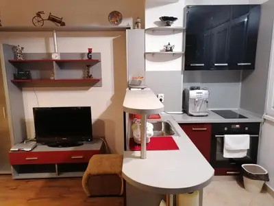 a small kitchen with a white counter and a tv at Kapana Comfy 2BR Apartment in Top Center in Plovdiv