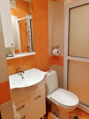 a bathroom with a toilet and a sink at Kapana Comfy 2BR Apartment in Top Center in Plovdiv