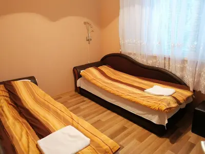 a bedroom with two beds and a window at Kapana Comfy 2BR Apartment in Top Center in Plovdiv