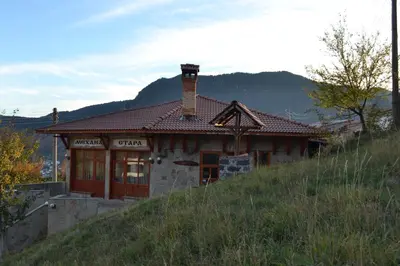 a house on top of a hill with a mountain at Family Hotel Silver in Smolyan
