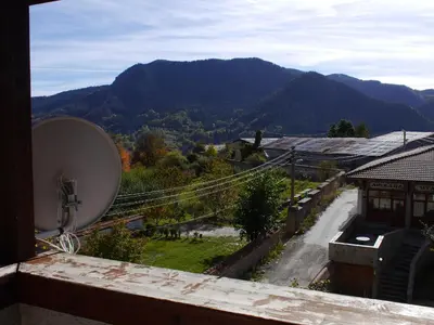 a view of the mountains from a balcony with a satellite at Family Hotel Silver in Smolyan