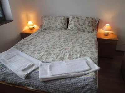 a bedroom with a bed with towels on it at Gramadeto Complex Alexander Services Apartments in Bansko