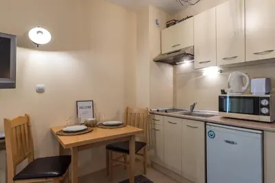 a kitchen with a small table and a microwave at ★ Stylish & Cozy Studios in Valentina Heights Boutique Hotel ★ in Bansko