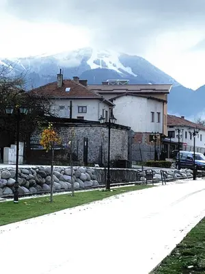 a building on a street with a mountain in the background at ★ Stylish & Cozy Studios in Valentina Heights Boutique Hotel ★ in Bansko