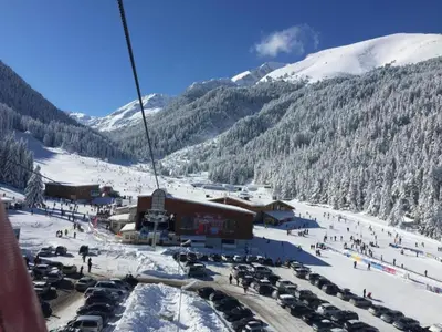 a ski resort with a bunch of cars in the snow at ★ Stylish & Cozy Studios in Valentina Heights Boutique Hotel ★ in Bansko