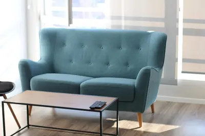 a blue couch in a living room with a coffee table at Turquoise and Magenta Apartment in Sofia