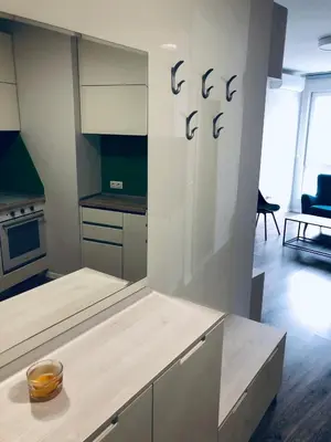 a kitchen with white cabinets and a bowl on a table at Turquoise and Magenta Apartment in Sofia