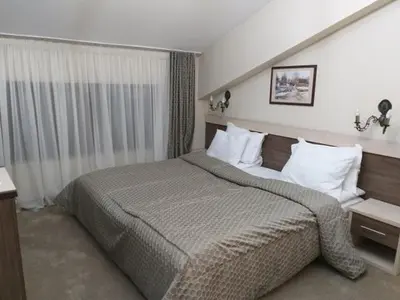 a bedroom with a large bed in a room at Spa Hotel Kleptuza in Velingrad