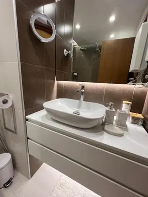 a bathroom with a sink and a mirror at Hotel Kardinal in Blagoevgrad