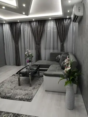 a living room with a couch and a table at City Apartments - a brand new luxury & comfy. in Asenovgrad