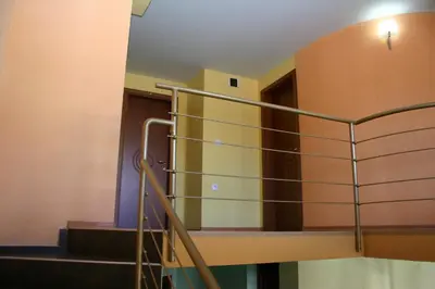 a set of stairs in a building with a railing at Family Hotel Studio in Sandanski