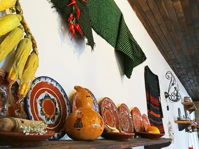 a group of plates and bowls on a shelf at Hotel Simona Complex in Sofia