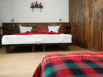 a bedroom with a bed with red blankets on it at Hotel Simona Complex in Sofia