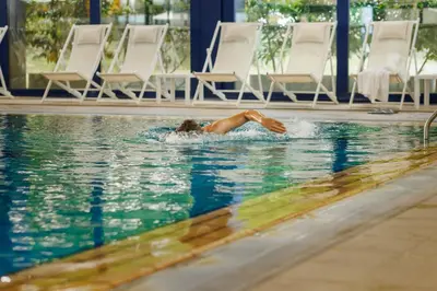 a woman swimming in a swimming pool at Interhotel Sandanski in Sandanski