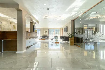 a large lobby with a reception desk in a building at Spa Hotel Orbita in Blagoevgrad