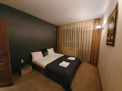 a bedroom with a bed with two towels on it at Simonen Apartments near the Gondola in Bansko