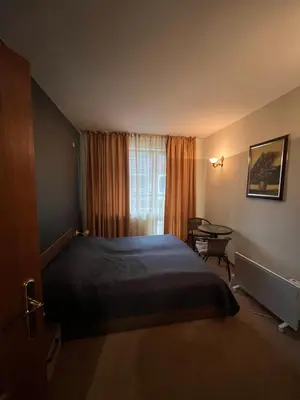 a bedroom with a large bed and a window at Simonen Apartments near the Gondola in Bansko