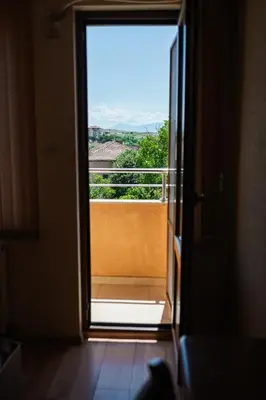 an open door with a view of a balcony at Семеен хотел Свети Георги in Sandanski