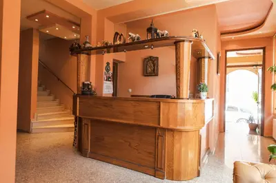a home hallway with a large wooden entertainment center at Семеен хотел Свети Георги in Sandanski