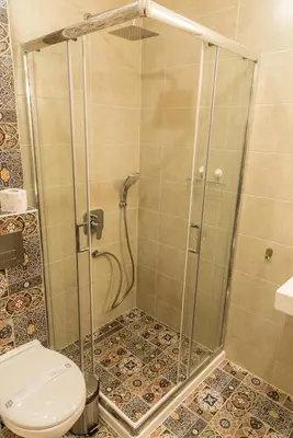 a shower stall with a toilet in a bathroom at Antique Residence in Hisarya