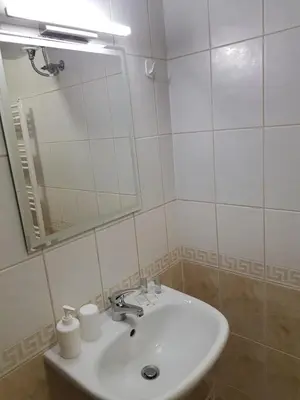 a bathroom with a sink and a mirror at Панорама Стойките Уют in Stoykite