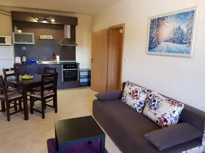 a living room with a couch and a table at Панорама Стойките Уют in Stoykite