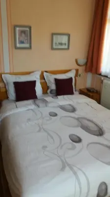 a large white bed with a design on it at Guest House Bolyarka in Koprivshtitsa