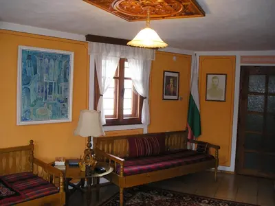 a living room with a couch and a window at Guest House Bolyarka in Koprivshtitsa