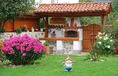 a doll in the yard of a toy house at Guest House Bolyarka in Koprivshtitsa