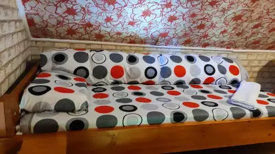a couch with polka dot pillows on it at Къща Семково in Semkovo
