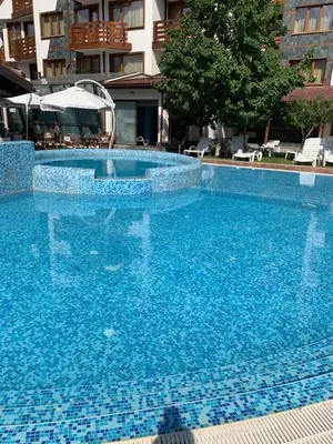 a large blue swimming pool in a building at Belvedere Holiday Club ...VIP ap. in Bansko