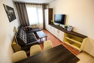 a living room with a couch and a television at Belvedere Holiday Club ...VIP ap. in Bansko