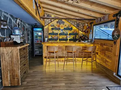 a bar in a restaurant with chairs in a room at Algara hut in Panichishte
