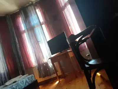 a room with a desk with a monitor and a chair at Pop Bogomil family hotel in Sofia
