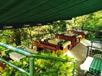 a group of tables and benches on a deck at Korona Hotel in Blagoevgrad