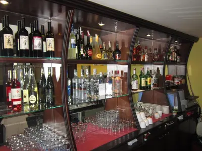 a bar with a lot of bottles of alcohol at Germanea Hotel in Sapareva Banya
